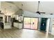 Inviting open living area with a kitchen island, sliding glass doors, and ample natural light at 2615 Autumn Green Dr, Orlando, FL 32822
