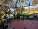 Cozy screened patio with barbecue grill and outdoor seating overlooking a pond at 2615 Autumn Green Dr, Orlando, FL 32822
