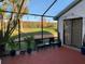 Inviting screened patio with outdoor seating, potted plants, and a beautiful golf course view at 2615 Autumn Green Dr, Orlando, FL 32822