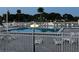 A pristine community swimming pool with lounge chairs and white picket fence surround at 2615 Autumn Green Dr, Orlando, FL 32822