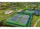 Aerial view of well-maintained tennis courts and playground amidst lush landscaping at 2615 Autumn Green Dr, Orlando, FL 32822