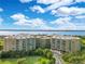 Scenic aerial shot of condo community featuring lush landscaping and water view at 4 Oceans West Blvd # 301B, Daytona Beach Shores, FL 32118