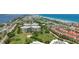 Panoramic aerial view of a condo complex, golf course, and coastline, showcasing a desirable location at 4 Oceans West Blvd # 301B, Daytona Beach Shores, FL 32118