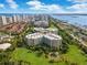 An aerial view showcases the condo community near the ocean and a serene river at 4 Oceans West Blvd # 301B, Daytona Beach Shores, FL 32118