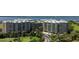 Scenic aerial shot of a condo community nestled on a golf course with beautiful tropical landscaping at 4 Oceans West Blvd # 301B, Daytona Beach Shores, FL 32118