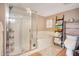 A bathtub and glass enclosed shower with shelves and tiled walls at 4 Oceans West Blvd # 301B, Daytona Beach Shores, FL 32118