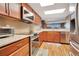 Kitchen featuring wood cabinets, granite counters, tile backsplash, and stainless steel appliances and oven at 4 Oceans West Blvd # 301B, Daytona Beach Shores, FL 32118