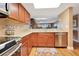 Updated kitchen featuring stainless steel appliances, granite counters, tile backsplash, and wood-look flooring at 4 Oceans West Blvd # 301B, Daytona Beach Shores, FL 32118