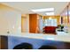 Cozy kitchen with granite counters and a breakfast bar that is open to the dining room and living room at 4 Oceans West Blvd # 301B, Daytona Beach Shores, FL 32118