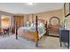 Comfortable bedroom featuring a four-poster bed, balcony access, and natural light at 4 Oceans West Blvd # 301B, Daytona Beach Shores, FL 32118