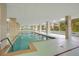 An indoor pool featuring large pillars, a mural, and plenty of light at 4 Oceans West Blvd # 301B, Daytona Beach Shores, FL 32118