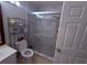 Bright bathroom features a glass shower enclosure and shelving for optimal organization at 4328 S Kirkman Rd # 1, Orlando, FL 32811