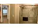 Modern bathroom with a glass-enclosed shower showcasing marble-patterned tiles and updated fixtures at 4328 S Kirkman Rd # 1, Orlando, FL 32811