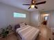 Comfortable bedroom with bright natural light, a ceiling fan, and easy access to a full bath at 4328 S Kirkman Rd # 1, Orlando, FL 32811
