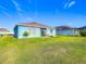 Spacious backyard with lush green grass and a private patio area at 452 Burnham Cir, Auburndale, FL 33823