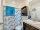 Bathroom with vanity, toilet, and shower with ocean themed curtain at 452 Burnham Cir, Auburndale, FL 33823