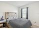 A comfortable bedroom features a patterned bedspread, a headboard with sconces, and a neutral color palette at 452 Burnham Cir, Auburndale, FL 33823