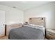 A comfortable bedroom features a patterned bedspread, a headboard with sconces, and a neutral color palette at 452 Burnham Cir, Auburndale, FL 33823