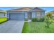 Charming single-Gathering home featuring a well-manicured lawn and two car garage at 452 Burnham Cir, Auburndale, FL 33823