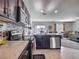 Modern kitchen featuring stainless steel appliances, granite countertops, and an open layout overlooking the living area at 452 Burnham Cir, Auburndale, FL 33823