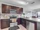 The kitchen has modern appliances and dark cabinets at 452 Burnham Cir, Auburndale, FL 33823