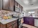 Well-lit kitchen includes stainless steel appliances and stone countertops at 452 Burnham Cir, Auburndale, FL 33823