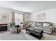 A cozy living room with a plush sectional sofa, elegant decor, and a neutral color palette at 452 Burnham Cir, Auburndale, FL 33823