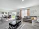 Bright, open living space features a plush sectional sofa, modern décor, and seamless indoor-outdoor flow at 452 Burnham Cir, Auburndale, FL 33823