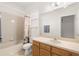 This bathroom has a large mirror, vanity, shower and tub combo with light-colored tiles at 5365 Dahlia Reserve Dr, Kissimmee, FL 34758