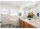 Bright bathroom with double sink vanity, soaking tub, and decorative accents at 5365 Dahlia Reserve Dr, Kissimmee, FL 34758