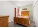 Bedroom with a wood bed frame, matching dresser, and neutral walls at 5365 Dahlia Reserve Dr, Kissimmee, FL 34758
