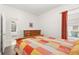 Bedroom with a light orange bed set and a matching dresser at 5365 Dahlia Reserve Dr, Kissimmee, FL 34758