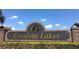 Crescent Lakes community entrance sign with brick columns and lush landscaping under blue skies at 5365 Dahlia Reserve Dr, Kissimmee, FL 34758