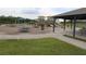Community playground featuring playground equipment, covered picnic area, tables, and open green space at 5365 Dahlia Reserve Dr, Kissimmee, FL 34758