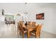 Bright dining room with wood table, seating for six, and neutral decor at 5365 Dahlia Reserve Dr, Kissimmee, FL 34758