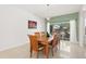 Elegant dining room featuring a wooden table with seating for six and a view of the outdoor space at 5365 Dahlia Reserve Dr, Kissimmee, FL 34758