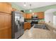 Modern kitchen with stainless steel appliances, and an island with bar seating at 5365 Dahlia Reserve Dr, Kissimmee, FL 34758