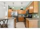 Cozy kitchen with wood cabinets, stainless steel appliances, and granite countertops at 5365 Dahlia Reserve Dr, Kissimmee, FL 34758