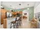 Well-equipped kitchen with barstool seating, wood cabinets, and stainless appliances at 5365 Dahlia Reserve Dr, Kissimmee, FL 34758
