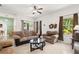 Bright living room with stylish sofas, neutral walls, and access to the backyard at 5365 Dahlia Reserve Dr, Kissimmee, FL 34758