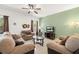 Comfortable living room featuring neutral walls, ceiling fan, and plush sofas at 5365 Dahlia Reserve Dr, Kissimmee, FL 34758