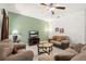 Inviting living room with plush sofas, neutral walls, and bright natural light at 5365 Dahlia Reserve Dr, Kissimmee, FL 34758