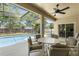 Covered patio features a ceiling fan and an outdoor dining set with views of the pool at 5365 Dahlia Reserve Dr, Kissimmee, FL 34758