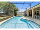 Beautiful screened-in pool area with blue tiled pool, seating, and lush plants, ideal for relaxation at 5365 Dahlia Reserve Dr, Kissimmee, FL 34758