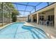 A refreshing screened-in pool area featuring a clean, inviting pool and an outdoor dining set at 5365 Dahlia Reserve Dr, Kissimmee, FL 34758