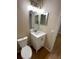 Bathroom featuring single sink vanity, white cabinets, and framed mirror at 541 Campus St, Celebration, FL 34747