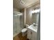 Bright bathroom features a glass enclosed shower, tile surround, and white vanity at 541 Campus St, Celebration, FL 34747