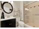 Cozy bathroom with tiled shower, stylish vanity, and elegant round mirror at 541 Campus St, Celebration, FL 34747