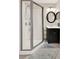 Bathroom showcasing a shower with a glass door, and modern vanity with a black cabinet at 541 Campus St, Celebration, FL 34747