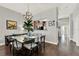 Stylish dining area showcasing a glass-top table, modern chairs, and hardwood flooring at 541 Campus St, Celebration, FL 34747